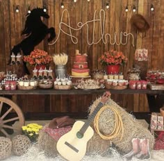 a table topped with hay bales covered in food