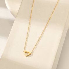 This beautiful piece features a heart outline pendant suspended from a delicate chain. Details: Stainless Steel 18k Gold Plated Dainty Heart Pendant Charm Necklace With Cable Chain, Delicate Open Heart Charm Necklace With Delicate Chain, Minimalist Heart Cable Chain Jewelry, Minimalist Heart Shaped Cable Chain Jewelry, Minimalist Heart Pendant Charm Necklace With Cable Chain, Minimalist Open Heart Charm Necklaces, Minimalist Open Heart Jewelry With Delicate Chain, Elegant Open Heart Charm Necklace With Delicate Chain, Delicate Open Heart Necklace With Delicate Chain