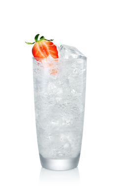 a tall glass filled with ice and a strawberry on the top is half full as it sits in front of a white background