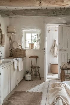 an old fashioned bathroom with white walls and floors