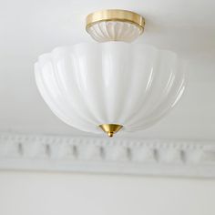 a white light fixture hanging from the ceiling