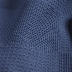 close up view of the texture of a blue fabric