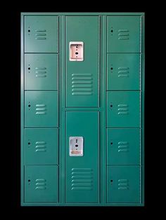 two rows of green lockers with one door open and the other closed, in front of a black background