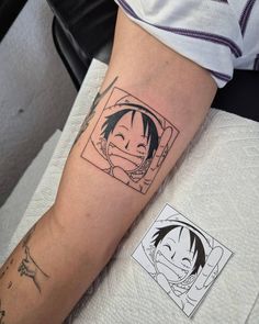 a person with a tattoo on their arm has a picture of an anime character in the background