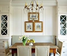 a dining room table with four chairs and a chandelier hanging from the ceiling