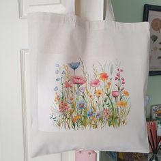 This lovely Wildflower cotton tote bag is perfect for anyone who loves nature and a great letterbox gift for her. Each tote is hand printed to order on a natural coloured tote which measures 38 x 42cm. Botanical Cotton Canvas Gift Bag, Floral Print Canvas Tote Bag As Gift, Floral Print Canvas Tote Bag For Gift, Botanical Cotton Bags As Gift, Botanical Cotton Bags As A Gift, Botanical Style Cotton Bags As Gift, Floral Print Cotton Bag For Gift, Floral Print Cotton Bags For Gifts, Cotton Floral Print Bag For Gifts