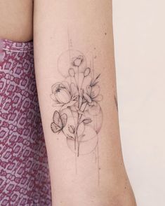 a woman with a tattoo on her arm has a flower and butterfly design on it