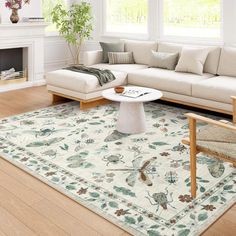 a living room filled with furniture and a large rug on top of a hard wood floor