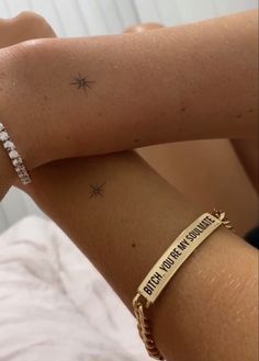 a woman wearing a gold bracelet with the words baby, you're my sunshine written on it