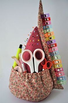 scissors and other crafting supplies in a bag with sequins on the sides