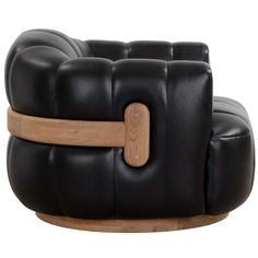 a black leather chair with wooden arms and legs