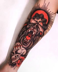 a person with a tattoo on their arm has a bear and skull in the background