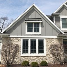 a gray house with white trim and windows