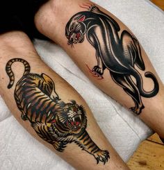 two people with tattoos on their legs and one has a tiger