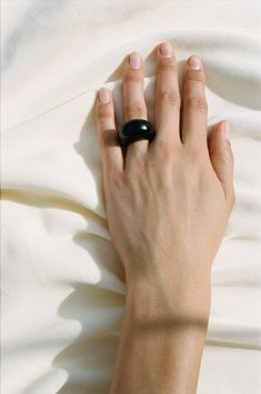 Sophie Buhai is a LA-based jewelry designer whose namesake line has renewed the modernist tradition of sterling silver with an emphasis on sculptural silhouettes. All of her pieces are hand made by artisans in Los Angeles using recycled metals. An iteration of the classic Onyx Donut Ring that is smaller. A simple yet elegant ring made with natural jade. 11mm perpendicular to finger16.2mm parallel to finger10.9g Variation in stone color and appearance may occur Handcrafted in Los Angeles Modern Onyx Open Ring Jewelry, Modern Black Enamel Open Ring Jewelry, Modern Black Dome Ring, Handmade Modern Onyx Jewelry, Modern Onyx Open Ring, Minimalist Sculptural Jewelry For Gifts, Modern Hand Forged Black Rings, Minimalist Sculptural Jewelry As Gift, Minimalist Sculptural Jewelry Gift