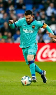 two men playing soccer on a field with fans in the stands watching from the stands