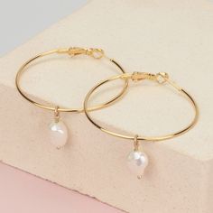 Our favorite classic big gold hoops earrings with a dangling freshwater pearl. 14k gold filled modern and delicate hoop earrings, lightweight for everyday wear. These gold-filled hoops with a dangling pearl are everything you need for summer. These large hoops are 1.5 inches in length and width (about 40mm in diameter). The wire thickness is 1.2mm Each freshwater pearl size is - approx. 8x13mm Hypoallergenic and tarnish-proof. This listing is for a PAIR of hoops earrings. ♥ Comes in a beautiful Big Gold Hoop Earrings, Hoop Earring Set, Simple Hoop Earrings, Handmade Jewelry Earrings, Baroque Pearl Earrings, Gold Filled Hoops, Hoop Earring Sets, Pearl Hoop Earrings, Pearl Size