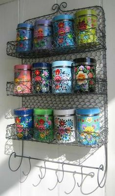 there is a metal shelf with many jars on it