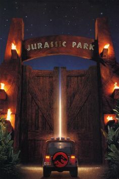 an advertisement for the movie's dinosaur park, featuring a car in front of a gate