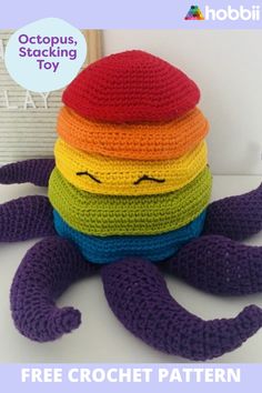 a crocheted stuffed toy with a rainbow colored hat on it