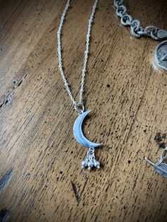 "Love this Sterling Silver Crescent Moon with it's bead bundle (stars anyone?) at about 1\" in length! A gorgeous combination of 2D and 3D and a little movement come together in this sweet design. It makes beautiful necklace on a 16\" or 18\" sterling beaded chain. A simple celestial gift or for yourself. These are pretty alone or stacked with other necklaces. Comes wrapped in a recycled-paper and velvet-ribboned gift box, per your request with no extra charge! - See options to the right. FREE d Moon Shaped Sterling Silver Jewelry For Mother's Day, Moon Shaped Jewelry With Star Charm For Gifts, Sterling Silver Moon Charm Jewelry For Mother's Day, Sterling Silver Jewelry With Moon Charm For Mother's Day, Sterling Silver Crescent Necklace With Charms, Bohemian Nickel-free Jewelry For Mother's Day, Mother's Day Sterling Silver Moon Charm Jewelry, Mother's Day Sterling Silver Jewelry With Moon Charm, Silver Charm Necklace With Moon Charm As Gift