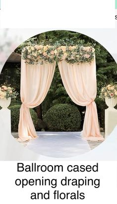 an outdoor wedding ceremony with pink drapes and flowers on the arch, surrounded by greenery