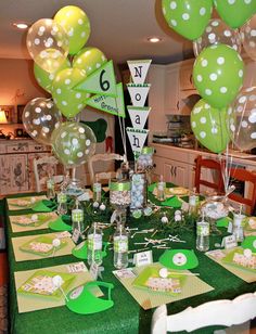 a table with green and white polka dot decorations