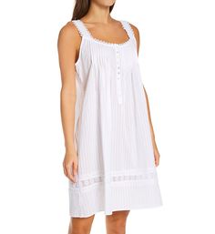 Subtle details add so much to this pretty, carefully crafted short nightgown. Made of woven 100% cotton. Dobby woven has a small diamond pattern alternating with sheer micro stripes. Low, rounded neckline trimmed with floral applique. Deep button placket at front with ten small genuine shell buttons. Placket opens for nursing if needed. Pleating across front ends at bust for a fuller fit. Wide straps are lace outside, with satin bands on the underside. Pintucks and a lace inset lined with sheer Summer Cotton Nightgown For Overnight Wear, Cotton Chemise For Sleep, Cotton Chemise For Bedtime, White Nightgown With Lace Trim, White Nightgown With Lace Trim For Overnight, White Lace Trim Nightgown For Overnight, Cotton Chemise With Lace Trim For Daywear, Daywear Cotton Chemise With Lace Trim, White Cotton Chemise