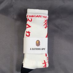 Crew Sock - White W/ Red Chinese Symbols And Babe Logo Trendy White Socks For Streetwear, Trendy White Streetwear Socks, Trendy Red Cotton Socks, Comfortable White Socks With Letter Print, White Breathable Cotton Socks, Casual Red Socks For Streetwear, Sporty Red Cotton Socks, White Sporty Socks For Winter, White Sporty Winter Socks