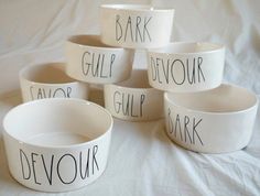 five white bowls with words written on them