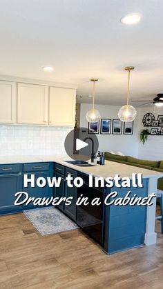 a kitchen with blue cabinets and white counter tops, in the middle of a living room