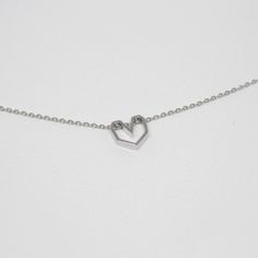 "Dimensions Heart size - 10mm The elegant chain style will perfectly accentuate your neck and collarbone. With a simple yet luxurious design, this pendant can easily complement any look, giving it completeness and accent. Materials and designs give a special shine to this piece that will beautify you. As a present Jewelry is a classical present that is versatile for all. It is an embodiment of noble and precious materials and the professional work of masters that makes each item a unique art obj Mini Charm Necklace, Silver Necklace Heart, Gold Wave Ring, Heart Charm Necklace, Heart Shaped Necklace, Necklace For Girlfriend, Mini Charm, A Wedding Dress, Necklace Heart