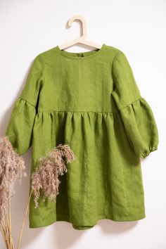 Lovely dress is with a subtle embroidered skirt and slightly puffed sleeves.  You can also choose without embroidery, Please let me know when you order. Model wearing OLIVE colors dress. Dresses in other colours:  https://www.etsy.com/your/shops/FlowermilkKids/tools/listings/769393841 -Medium weight linen (180g/m) -Made from Oeko-Tex certified 100 % linen fabric  (guaranteeing that no harmful chemicals have   been used during the manufacturing process assuring your safety) -Pure washed linen loo Cotton Dresses With Bishop Sleeves For Spring, Green Embroidered Linen Dress, Green Cotton Dress With Gathered Sleeves, Linen Dress Embroidery, Olive Colored Dress, Green Boho Dress, Girls Spring Dresses, Long Sleeves Dress, Dress Embroidery