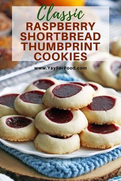 some cookies are stacked on top of each other with raspberry shortbread thumbprint cookies