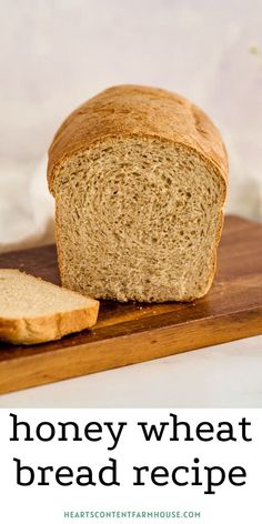 a loaf of bread sitting on top of a cutting board next to a slice of bread