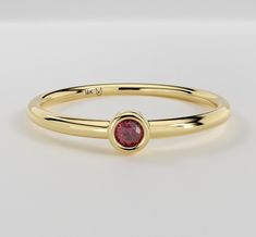 A minimalist design solitaire ring featuring a single bright red Ruby surrounded with a halo of yellow gold.   Metal - 14K Yellow Gold Finger Sizes available - 4 to 9 (Other sizes available upon request) Gemstone Type - Natural Ruby Shape - Round Brilliant Cut  Size - 2.0mm Diameter  Weight - 0.05 carats The item is handcrafted and made to order so you can ensure you'll receive a brand-new piece made just for you. Items ship within 2 - 3 weeks. If you would like to have this style customized, se Classic Yellow Gold Birthstone Ring With Halo, Gold Ruby Ring With Halo In 14k Gold, Gold Ruby Halo Ring In 14k, Yellow Gold Ruby Ring With Halo Design, 14k Gold Red Stackable Rings, Red 14k Gold Stackable Round Rings, Red 14k Gold Stackable Rings, 14k Gold Ruby Ring With Halo Design, Yellow Gold Ruby Ring With Tension Setting