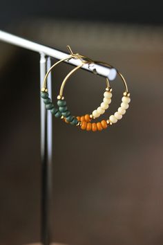 Unique boho earrings with glass seed beads (forest green,ivory,mustard colors), small gold tone metal beads and gold tone stainless steel round hoop earrings. Earring hooks are from nickel free and lead free metal. Perfect jewelry for everyday wear or a great gift for someone special! Diameter of hoops is 25 mm Other earrings of my shop you can see here: https://www.etsy.com/shop/NaTavelli?section_id=13757927  Thanks for visit. Everyday Green Round Beaded Earrings, Hypoallergenic Green Round Bead Earrings, Unique Green Round Beaded Earrings, Green Brass Earrings With Round Beads, Nickel-free Small Hoop Green Beaded Earrings, Boho Hoop Earrings, Beaded Rings, Green Bead, Metal Beads