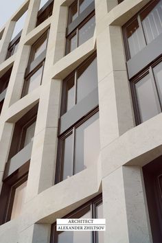 a tall white building with lots of windows on it's sides and the words archittict above them