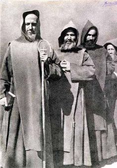 an old black and white photo of men in medieval garb holding tennis racquets