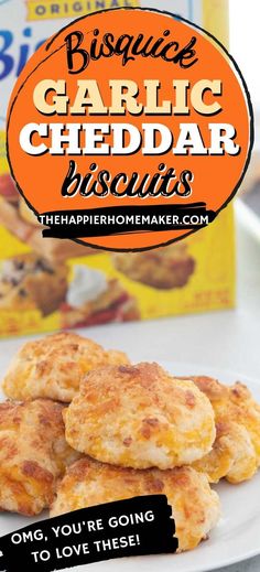 some biscuits are on a white plate next to a carton of garlic cheddar biscuits