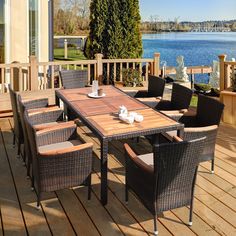 an outdoor table and chairs on a wooden deck