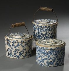 three blue and white ceramic containers with handles