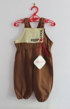 FRENCH VINTAGE 80's, very cute dungarees / overalls, brown soft  jersey fabric ( cotton 50 % and acrylic ), keep cool print. Brand " Mignard ". Size 6 months Total length "  / Width ( underarms ) " Vintage condition level 5, new old stock  We assess the condition of our vintage items on a scale from 0 to 5. Level 5 corresponds to an almost new vintage condition. Any defects are systematically reported. Even though in very good condition, vintage items may present imperfections due to their age, Cute Dungarees, Overalls Brown, Jersey Jumpsuit, Level 5, Keep Cool, Gender Neutral Baby, Dungarees, New Vintage, Jersey Fabric