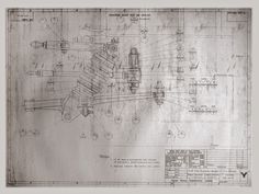 a drawing of a plan for a building with drawings on the wall and below it