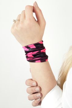 "Hot Pink Letters Wide Stretch Wrist Cuff Bracelet by ForgottenCotton Limited Edition! Adding a pop of bright color and pattern to your day. Our neon pink letters wrist cuff is fun bright accessory. This limited edition wrist cuff features hot pink letters on a shiny black background. Dressed up or down, covering a tattoo, or worn for a splash of color- it is versatile, cute, and sure to get tons of compliments Why we love it: Our cuffs are made to be versatile. Perfect worn straight or scrunche Adjustable Band Bracelet, Trendy Black Band Bracelets, Adjustable Band Wristband With Bracelet Strap, Adjustable Pink Band Bracelet, Adjustable Festival Wristband, Adjustable Band Wristband For Festivals, Trendy Adjustable Wristband, Black Band Cuff Bracelet For Gifts, Black Band Cuff Bracelet As A Gift