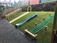 an artificial playground with a slide and climbing bars