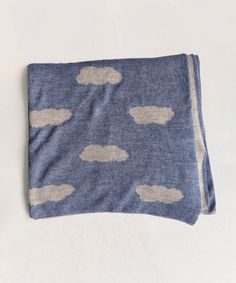 a blue blanket with white clouds on it