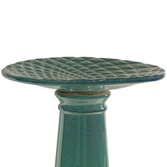 a green glass plate sitting on top of a table