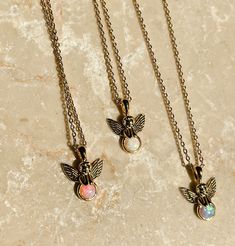 "Everyone needs a sweet little guardian angel !  Petite Angel Charm that has little wings that flutter, framing a gorgeous bright Opal !  Please choose which necklace you would like!   -Length: 16\" chain with lobster claw closure\"  - Gold plated chain and charm This makes a lovely little gift that will make a huge impact!  This listing is for one necklace. ------------------------------------------------------------------------------------------- This necklace looks great paired with my star crossed Y Necklace! https://www.etsy.com/listing/653716343/star-crossed-y-necklace-choker-necklace?ref=shop_home_active_1 ---------------------------------------- This item comes gift wrapped in signature BC wrapping and free gift. Also comes with a FREE GIFT!!" Angel Wings Jewelry Gift, Angel Winged Jewelry For Gifts, Angel Wings-shaped Jewelry As Gift, Angel Wings-shaped Jewelry For Gifts, Fairy Pendant Jewelry Gift, Fairy Style Pendant Jewelry Gift, Angel Wings Pendant Jewelry Gift, White Angel Wings Jewelry As Gift, Angelic White Jewelry For Gifts