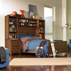 a bedroom scene with focus on the bed and bookcase in the foreground, and an open door leading to another room